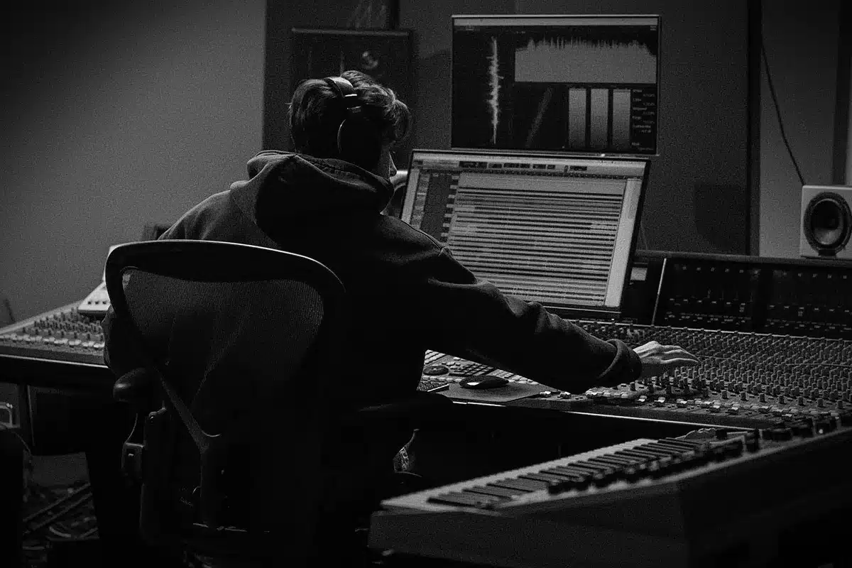戴兜帽的Ghost Producer在录音棚调音台前工作